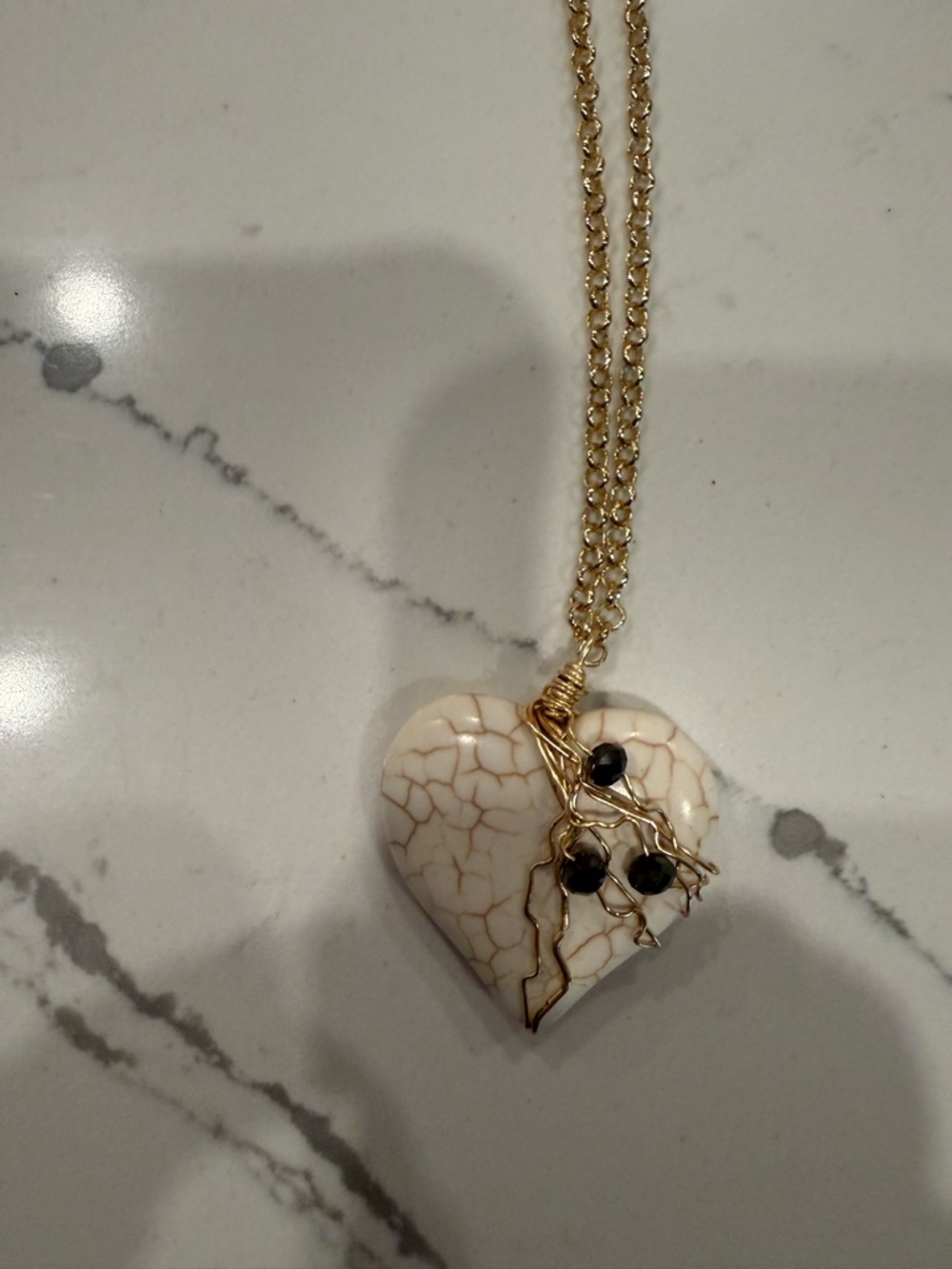 Gold Chain Necklace with Cream Heart Pendant and Black Accent Beads